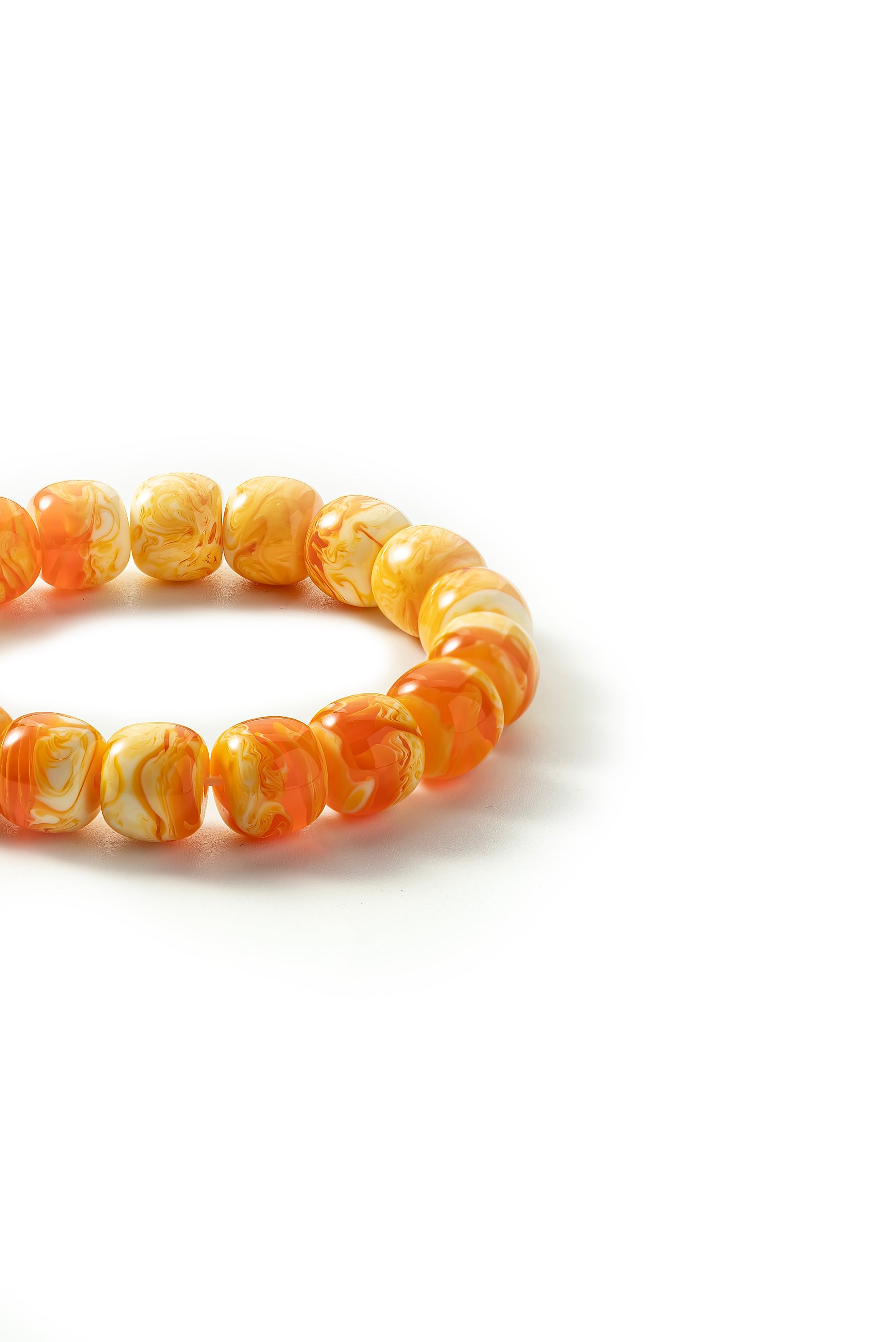Orange beaded bracelet on a white background