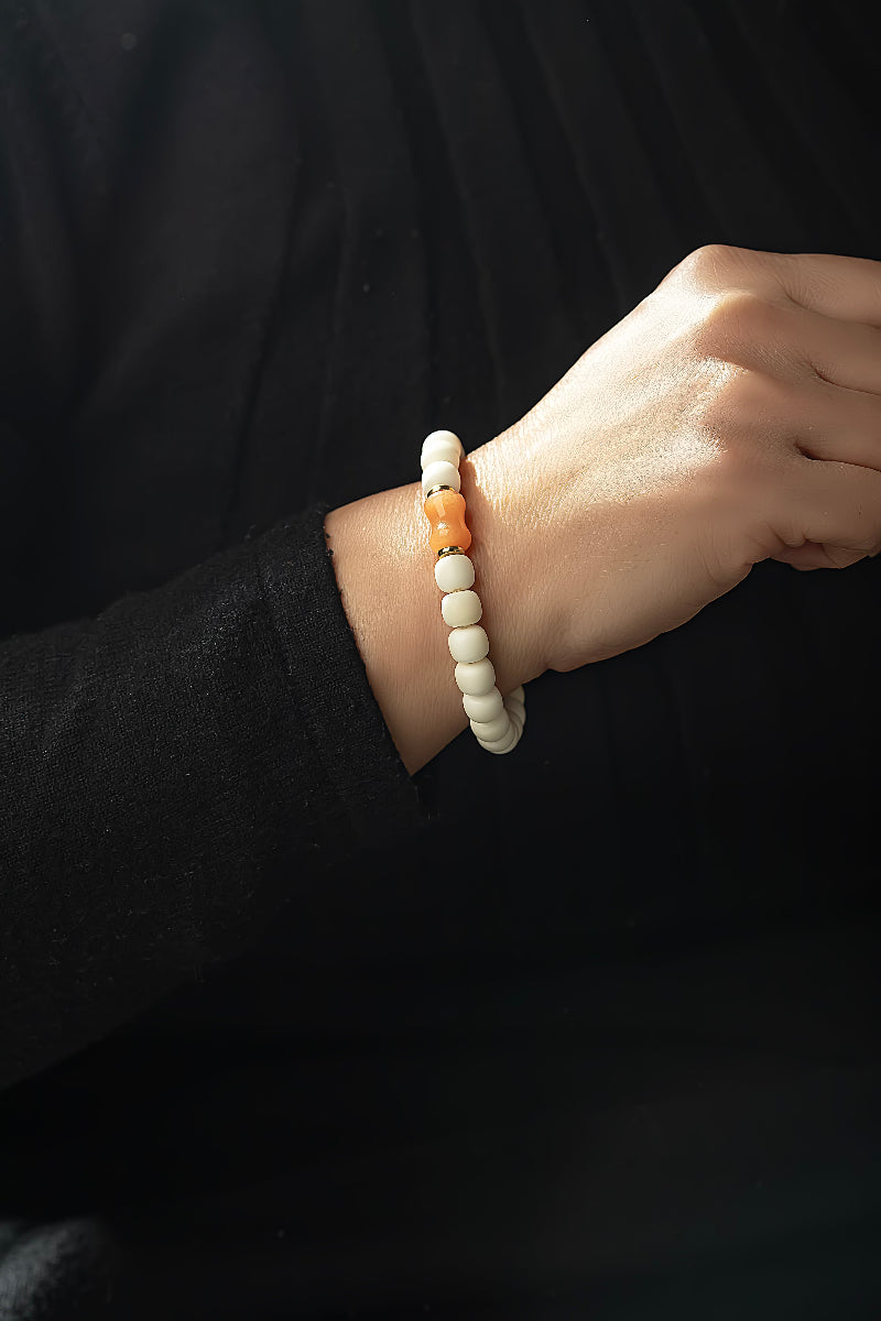 Close-up of a wrist wearing a bracelet with a black background