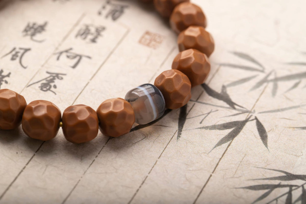 Brown beaded bracelet on a piece of paper with Chinese characters